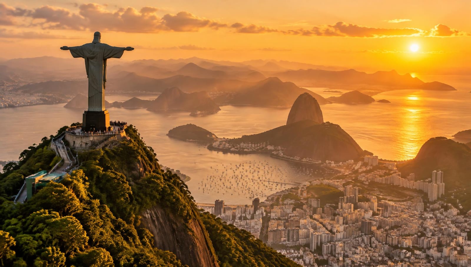 Christ the Redeemer statue overlooking Rio de Janeiro at sunset, with Sugarloaf Mountain and Guanabara Bay in the background